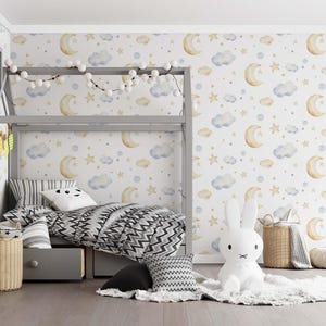 May include: A child's bedroom with a gray bunk bed, patterned bedding, and a white bunny lamp. The walls are decorated with a celestial pattern of moons, stars, and clouds. Wicker baskets and a fluffy rug add to the cozy atmosphere.