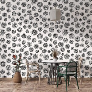 May include: A black and white abstract wallpaper with a repeating pattern of swirling circles. The wallpaper is shown in a room with a table and chairs.