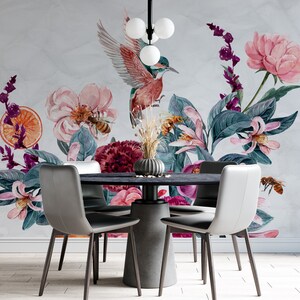 May include: A dining room set featuring a round black table and four gray chairs. The wall behind the table is adorned with a floral mural, including a hummingbird, bees, and various flowers in shades of pink, purple, and orange.