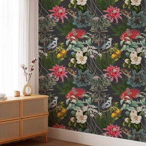 May include: A dark gray wallpaper with a repeating pattern of pink flowers, blue birds, and green leaves. The wallpaper has a vintage feel and would be a great addition to any home.