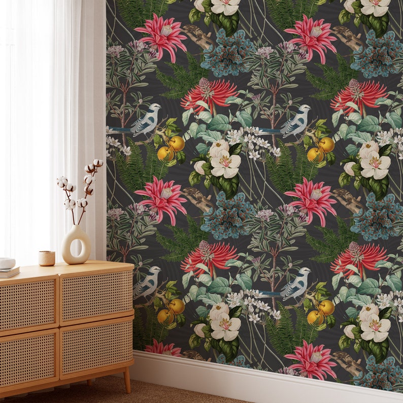 May include: A dark gray wallpaper with a repeating pattern of pink flowers, blue birds, and green leaves. The wallpaper has a vintage feel and would be a great addition to any home.