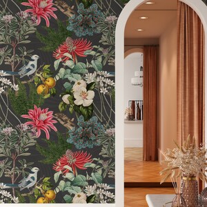 May include: A dark gray wallpaper with a repeating pattern of white flowers, red flowers, blue flowers, green leaves, yellow fruit, and blue birds. The wallpaper is shown in a room with a doorway and a wooden floor.
