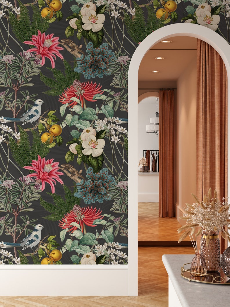 May include: A dark gray wallpaper with a repeating pattern of white flowers, red flowers, blue flowers, green leaves, yellow fruit, and blue birds. The wallpaper is shown in a room with a doorway and a wooden floor.