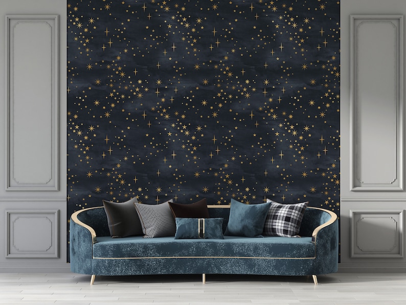 May include: A dark blue velvet sofa with gold trim sits in front of a wall with a navy blue and gold star pattern wallpaper. The sofa has several throw pillows in various patterns and colors.