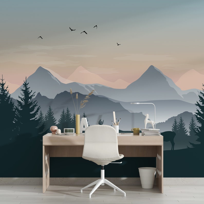 May include: A white office chair with a wooden desk in front of a wall mural depicting a mountain range with a blue and pink sunset. The mural features a silhouette of trees and a deer.