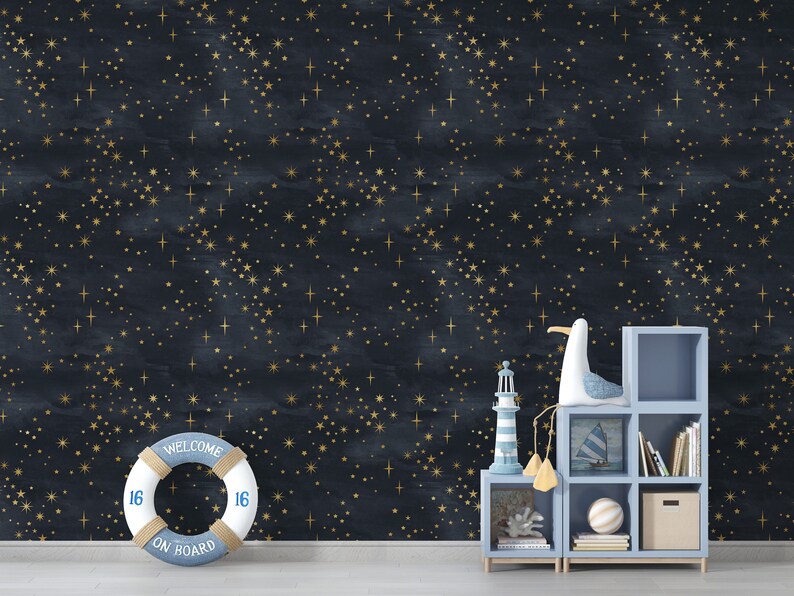 May include: A dark blue wall with a gold star pattern. A white life preserver with the text "Welcome On Board" is in the foreground. A blue shelf unit with a seagull figurine, a lighthouse, and books is in the right corner.