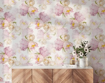 May include: A wooden cabinet with a white marble top and three drawers. The cabinet is in front of a wall with a floral wallpaper featuring pink and white peonies.