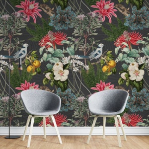 May include: A dark gray wallpaper with a floral and bird pattern. The wallpaper features white, pink, blue, and yellow flowers, as well as blue birds. The wallpaper is shown in a room with two gray chairs.