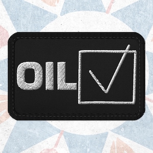 May include: Black embroidered patch featuring the word "OIL" in white, with a white tick inside a white square. The patch has a black border.