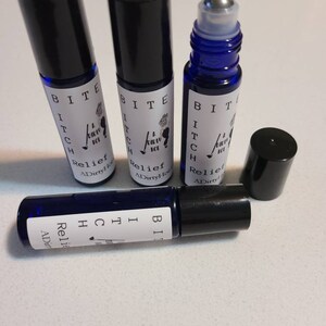 May include: Four blue glass roller bottles with black caps. The bottles are labeled with white text that reads "BITE ITCH Relief A DirtyHor".