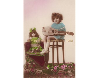 Vintage postcard ∙ Charming little girl playing a mandolin tune to her pretty doll