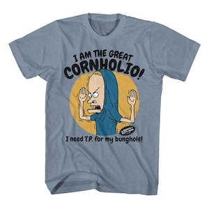 May include: Light blue t-shirt featuring a cartoon character with the text "I AM THE GREAT CORNHOLIO!" above the character and "I need T.P. for my bunghole!" below. The character is inside a yellow circle.