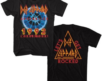 May include: Two black t-shirts with a Def Leppard design. The front shirt features a blue eye with the text "Def Leppard, Adrenalize, 1992 World Tour". The back shirt features a triangle with the text "Let's Get Rocked" and the Def Leppard logo.
