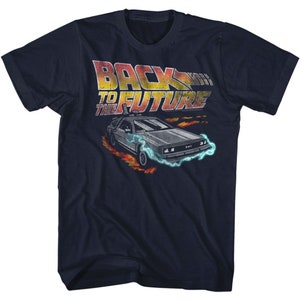 May include: A navy blue t-shirt with a faded graphic of the DeLorean time machine from the movie "Back to the Future". The text "Back to the Future" is printed in orange and yellow.
