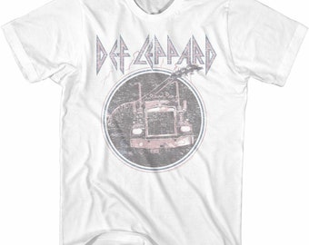 May include: White t-shirt with a vintage-style graphic of a semi-truck in front of a black circle with the band name "Def Leppard" in white text above the truck.
