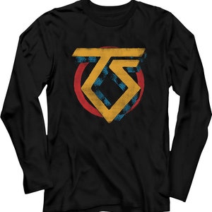 May include: Black long-sleeve shirt featuring a distressed, geometric design in yellow and blue, set against a red circle. The design includes the letters "TS".
