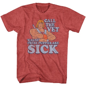 May include: Red t-shirt with a vintage-style graphic of He-Man, a muscular cartoon character with a sword, and the text "Call the Vet 'Cause These Puppies Are Sick".