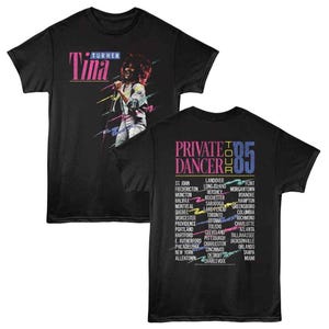 May include: Black t-shirt featuring a graphic of Tina Turner with the text "TURNER Tina" in pink and purple. The back of the shirt displays "PRIVATE DANCER TOUR '85" with a list of tour cities in various colors.