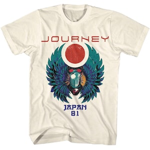 May include: White t-shirt with a Journey logo featuring a scarab beetle with wings and a red circle. The text "Journey" is above the logo and "Japan 81" is below.