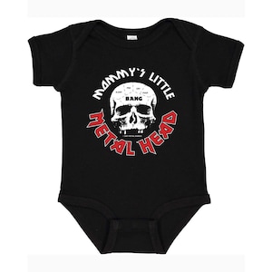 May include: Black baby onesie with a white skull graphic and the text "Mommy's Little Metal Head" in red. The skull has a brain with the words "Sleep, Pee, Cry, Bang, Poop" inside.