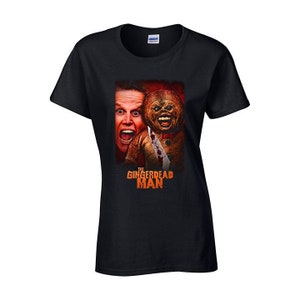 May include: Black t-shirt with a graphic of a man and a gingerbread man with the text "The Gingerdead Man" in orange.