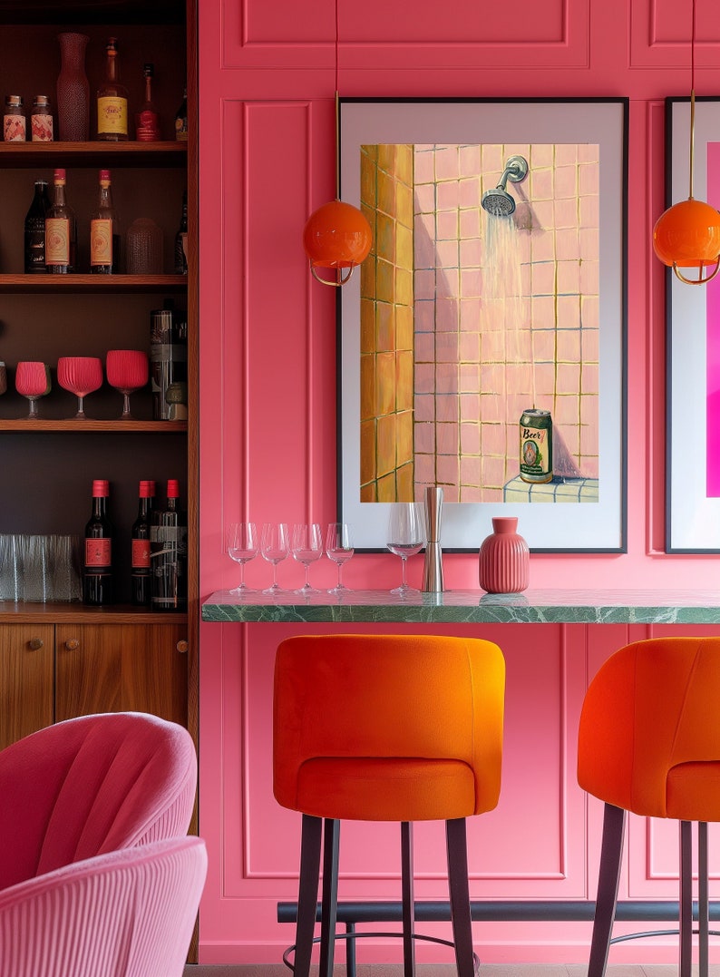 May include: A vibrant pink bar area with orange velvet bar stools and a green marble countertop. Artwork depicts a shower scene with a beer can. Wine glasses and bottles are displayed on shelves, complemented by orange globe pendant lights.