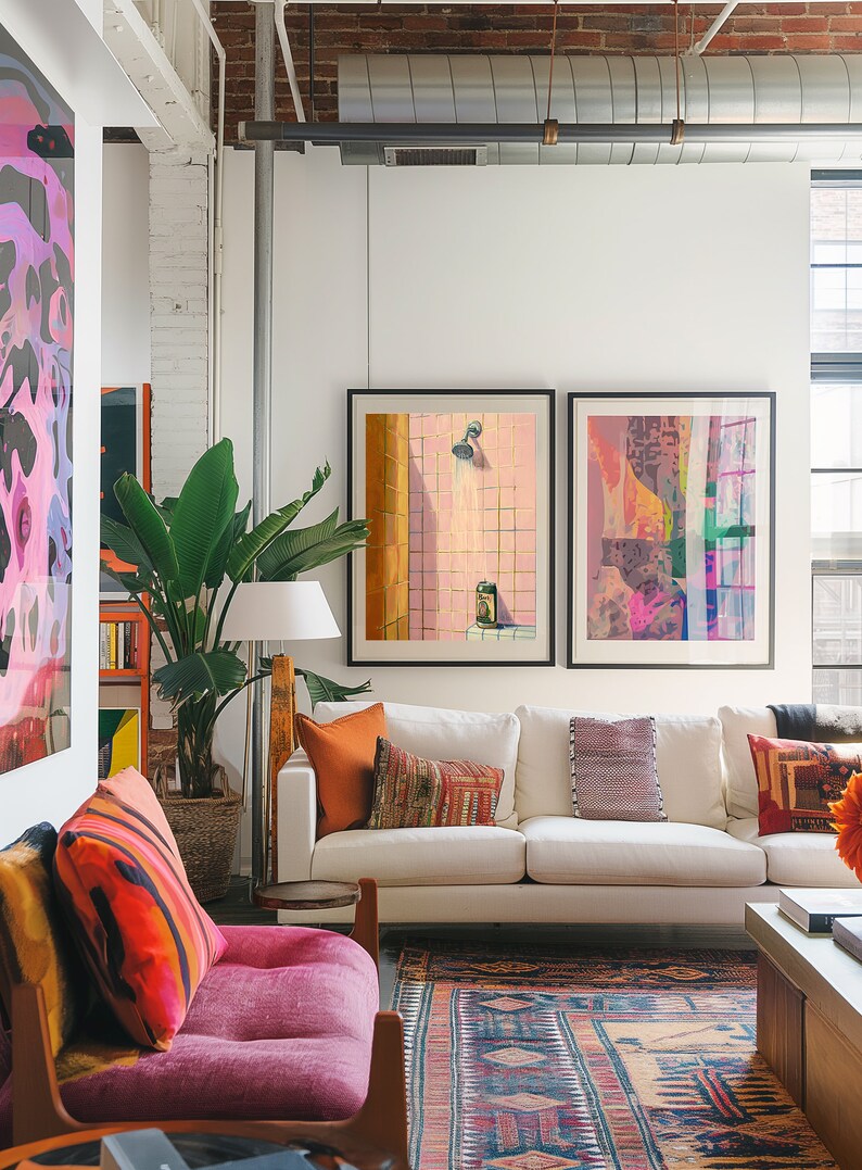 May include: A modern living room with a white sofa, colorful throw pillows, and framed artwork. A large potted plant and a patterned rug add to the room's decor. The artwork includes a painting of a shower.