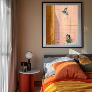 May include: A framed artwork depicts a shower scene with pink tiles and a beer can. The bedroom setting includes a bed with orange and yellow bedding, a side table with a lamp, and a window with sheer curtains.