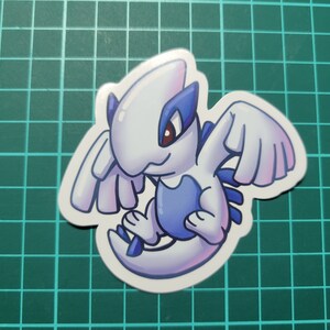May include: A white and blue cartoon sticker of a mythical creature with wings. The creature has a blue body and white wings. The creature is looking to the left.
