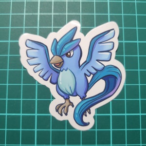 May include: A blue and white cartoon sticker of a bird-like Pokemon with a long tail and wings spread out.
