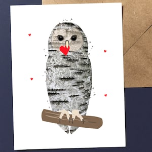 May include: A greeting card featuring an owl illustration. The owl has a birch bark pattern, large eyes, and a red heart-shaped beak. It is perched on a brown branch, with small red hearts scattered around it. The card is on a white background.