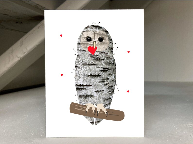 May include: A greeting card featuring a whimsical owl illustration. The owl has a textured, birch-like pattern in shades of gray and white, with a red heart-shaped beak. It is perched on a brown branch, with small red hearts scattered around.