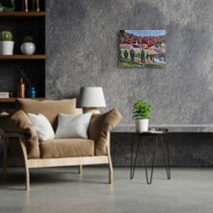 May include: A painting of a rural landscape with a white church building, green trees, and a small body of water. The painting is framed and hanging on a gray wall.