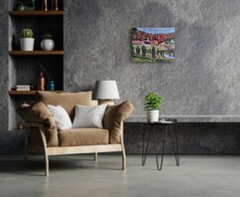 May include: A painting of a rural landscape with a white church building, green trees, and a small body of water. The painting is framed and hanging on a gray wall.
