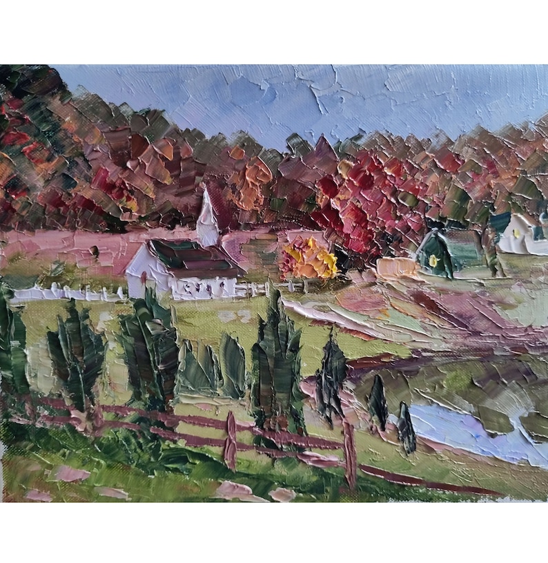 May include: A painting of a white church with a brown roof in a rural landscape. The church is surrounded by trees with red, orange, and yellow leaves. There is a white picket fence in front of the church.