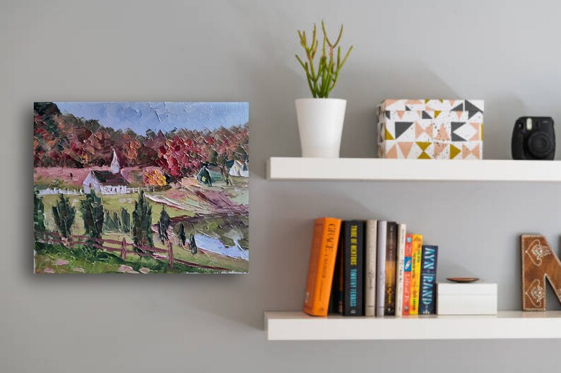 May include: A painting of a white church with a steeple in a rural setting. The church is surrounded by trees with red, orange, and yellow leaves. The painting is done in a loose, impressionistic style.