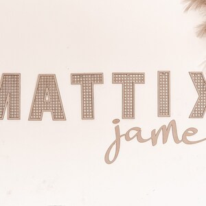 May include: Beige wooden letters spelling "MATTIx james" on a white background. The letters are woven with a grid pattern.