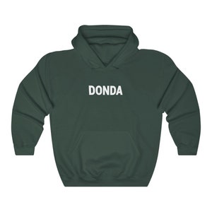 May include: A dark green hooded sweatshirt with the word "DONDA" printed in white on the front.