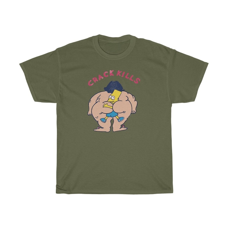 May include: A green t-shirt featuring a cartoon image of a yellow character wearing blue shorts and a black hairdo. The text "CRACK KILLS" is printed in pink above the image.