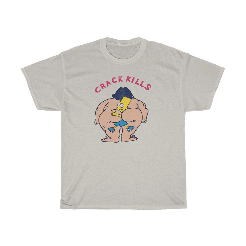 May include: A white t-shirt featuring a cartoon image of a large, yellow character with a blue shirt and black hair. The character is holding a smaller, yellow character with black hair. The text "CRACK KILLS" is above the characters.