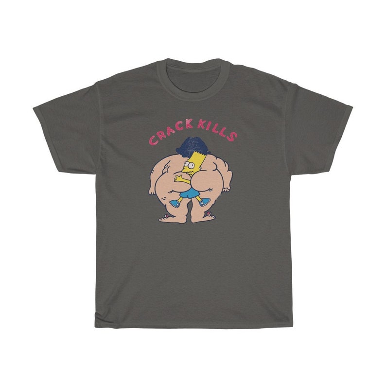 May include: A dark grey t-shirt featuring a cartoon image of a yellow character with blue shorts and black hair. The character is being hugged by a larger, nude character with black hair. The text "CRACK KILLS" is printed in pink above the characters.