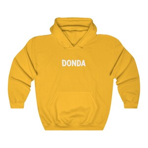 May include: A yellow hoodie with a white "DONDA" logo printed on the front.