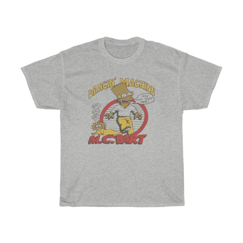 May include: A grey t-shirt featuring a cartoon image of Bart Simpson as a rapper. The text "Dancin' Machine" and "M.C. Bart" are printed on the shirt. The cartoon Bart Simpson is wearing a yellow shirt, blue jeans, and a backwards baseball cap. He is holding a microphone and has a surprised expression on his face. The text "You can't touch this!" is printed in a speech bubble above Bart Simpson's head.
