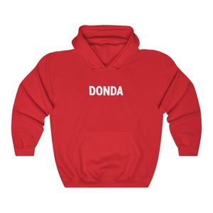 May include: Red hooded sweatshirt with the word "DONDA" printed in white on the front.