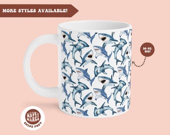 May include: White ceramic mug with a repeating pattern of blue and gray sharks. The mug has a large handle and says "20 oz. BIG!" on the side.