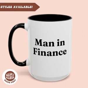 May include: White ceramic mug with a black interior and handle. The mug features the text "Man in Finance" in a bold, black font. The mug has a glossy finish and is suitable for hot or cold drinks.