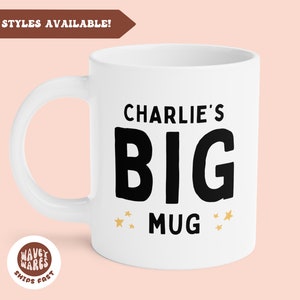 May include: White ceramic mug with the text "Charlie's BIG MUG" in black, with gold star accents. The mug has a white handle and the words "MORE STYLES AVAILABLE!" are in a brown banner.