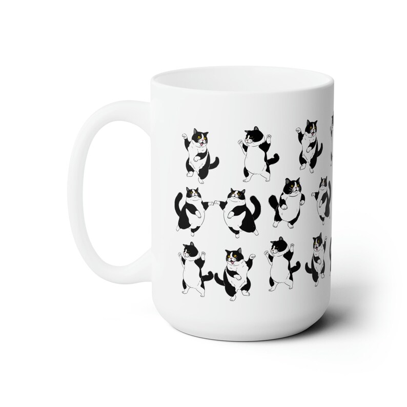 May include: White ceramic mug featuring a repeating pattern of cartoon tuxedo cats in various poses. The cats are black and white with yellow eyes. The mug has a large handle and a smooth, glossy finish.