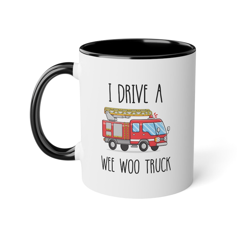 May include: White ceramic mug with a black rim. The mug has a red and yellow cartoon fire truck with the text "I drive a wee woo truck" printed on it.