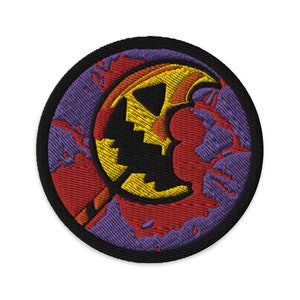 May include: A round embroidered patch with a purple, red, and yellow design. The design features a crescent moon with a face and a yellow stick.